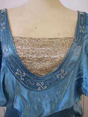 Lot 10 - A 1930's blue satin dress, with rounded...