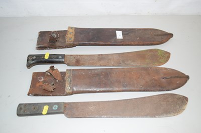 Lot 1 - Two small machetes or bush knives in leather...