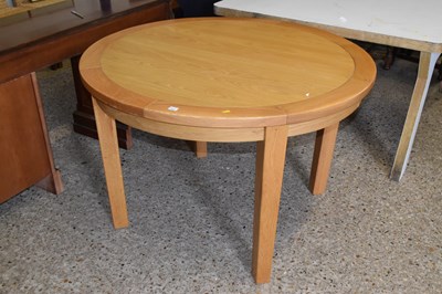 Lot 257 - A modern light wood extending dining table