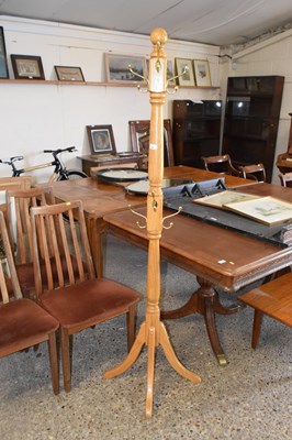 Lot 305 - A light oak coat stand on four footed base