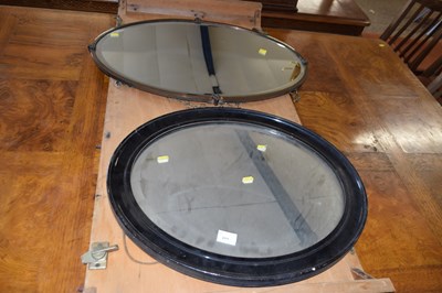 Lot 311 - An oval bevelled wall mirror in metal frame...