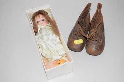 Lot 518 - A small porcelain headed doll and a pair of...