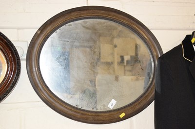 Lot 651 - An early 20th Century oval wall mirror in dark...