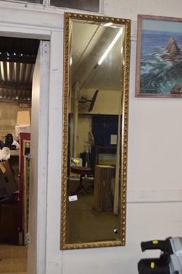 Lot 682 - A rectangular bevelled wall mirror in gilt...
