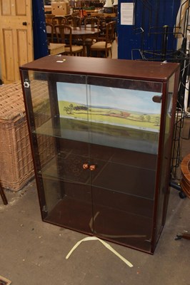 Lot 818 - A dark wood finish glazed bookcase