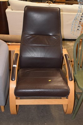 Lot 824 - A modern brown leather upholstered chair