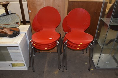 Lot 830 - A set of eight red painted stacking chairs
