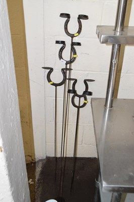 Lot 860 - Five horseshoe coconut holders