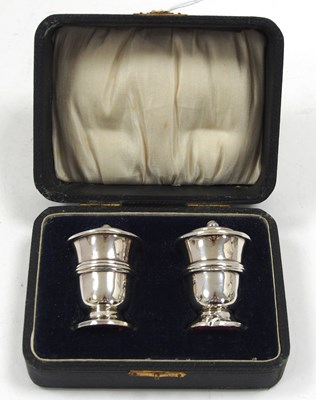 Lot 77 - A cased pair of hallmarked silver peppers,...