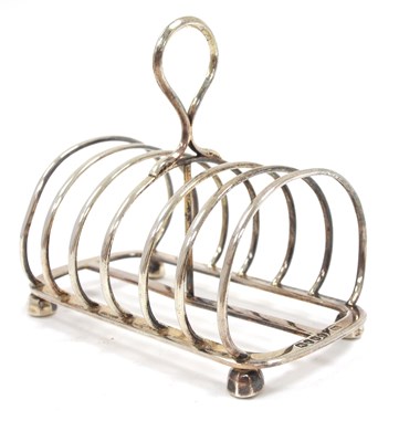 Lot 120 - A Victorian silver toast rack of six divisions,...