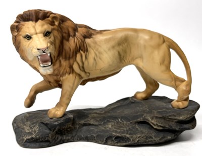 Lot 243 - A large Beswick model of a lion on shaped...