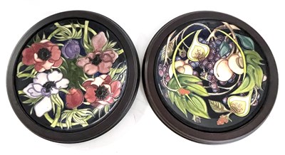 Lot 271 - Two Moorcroft chargers in wooden frames, one...