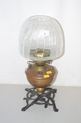 Lot 2 - A small oil lamp with clear glass shade,...