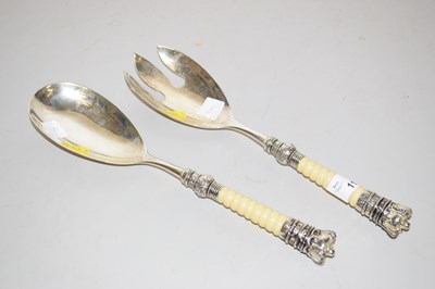 Lot 111 - A pair of silver plated and ivorine salad servers