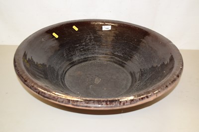 Lot 144 - A large brown glazed bowl, 57cm diameter