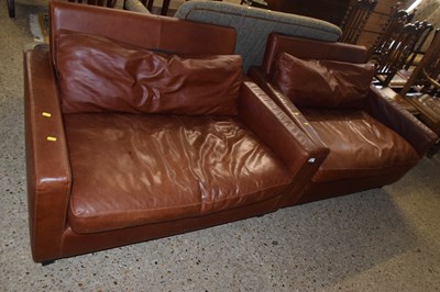 Lot 255 - A pair of brown leather snuggle type sofas