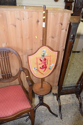 Lot 274 - A mahogany pole screen decorated with a panel...