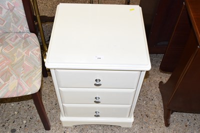 Lot 299 - A cream painted three drawer bedside cabinet
