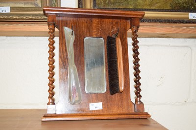 Lot 341 - A small wall mirror with barley twist supports