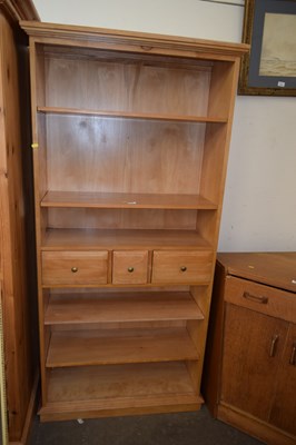 Lot 770 - A modern light wood bookcase cabinet