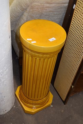 Lot 849 - A dark yellow ceramic jardiniere stand