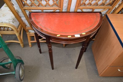 Lot 863 - A reproduction demi lune side table