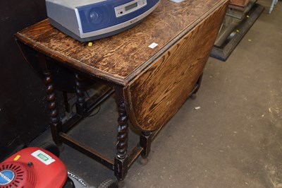Lot 873 - An oak drop leaf dining table