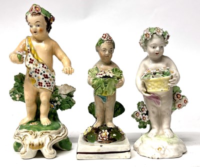 Lot 296 - An 18th Century Derby putto holding a basket...