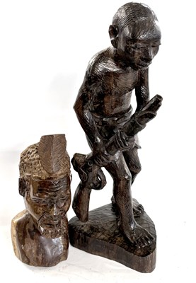 Lot 369 - A West African hardwood carving of a figure...