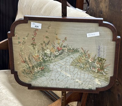 Lot 426 - A Victorian and later pole screen decorated...