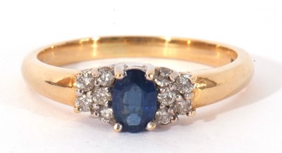 Lot 44 - Sapphire and diamond ring centring an oval...