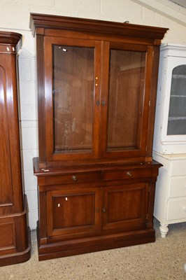 Lot 215 - A modern two piece display cabinet with glazed...