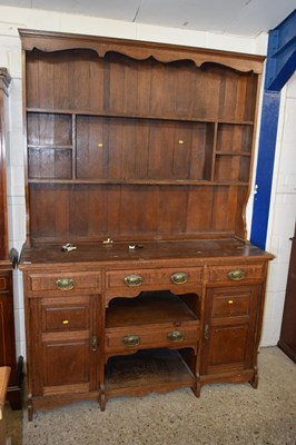 Lot 218 - A late Victorian oak dresser with shelved back...