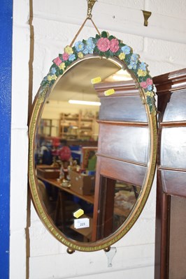 Lot 223 - A vintage oval mirror in floral mounted frame