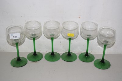 Lot 509 - A set of six green stemmed wine glasses