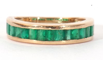 Lot 112 - Modern 9ct gold and emerald half hoop ring...