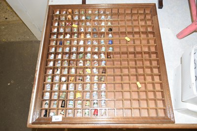Lot 631 - A wooden display rack of thimbles