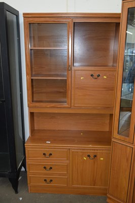 Lot 662 - A modern teak finish lounge display cabinet