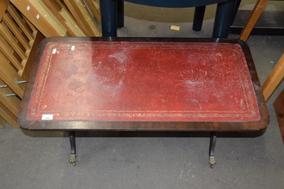 Lot 699 - A leather topped coffee table
