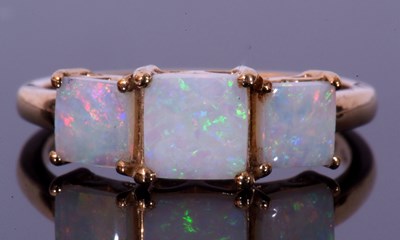Lot 124 - Modern 9ct gold and white opal three stone...