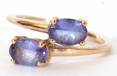 Lot 129 - Modern 9ct gold and tanzanite cross-over ring,...