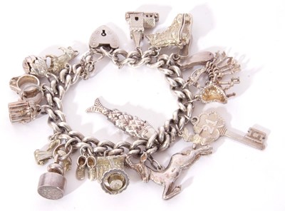 Lot 265 - Silver curb link bracelet suspending various...