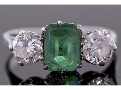 Lot 186 - Emerald and diamond three stone ring, the...