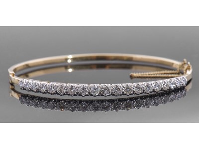 Lot 202 - 18ct gold and diamond hinged bracelet of oval...