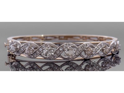 Lot 204 - Diamond set hinged bracelet, featuring seven...