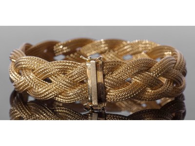 Lot 230 - 750 stamped bracelet, a woven plaited design,...