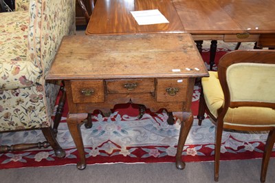 Lot 469 - Georgian oak three drawer lowboy raised on...