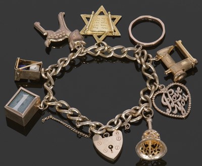 Lot 367 - 9ct gold curb link bracelet suspending various...