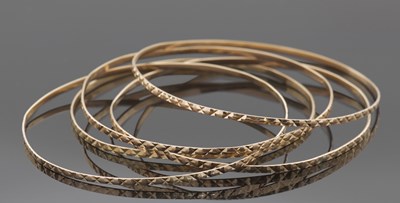 Lot 396 - Five matching mid-grade yellow metal bangles...