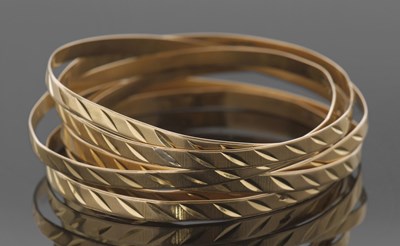 Lot 397 - Six matching yellow metal bangles, engraved...